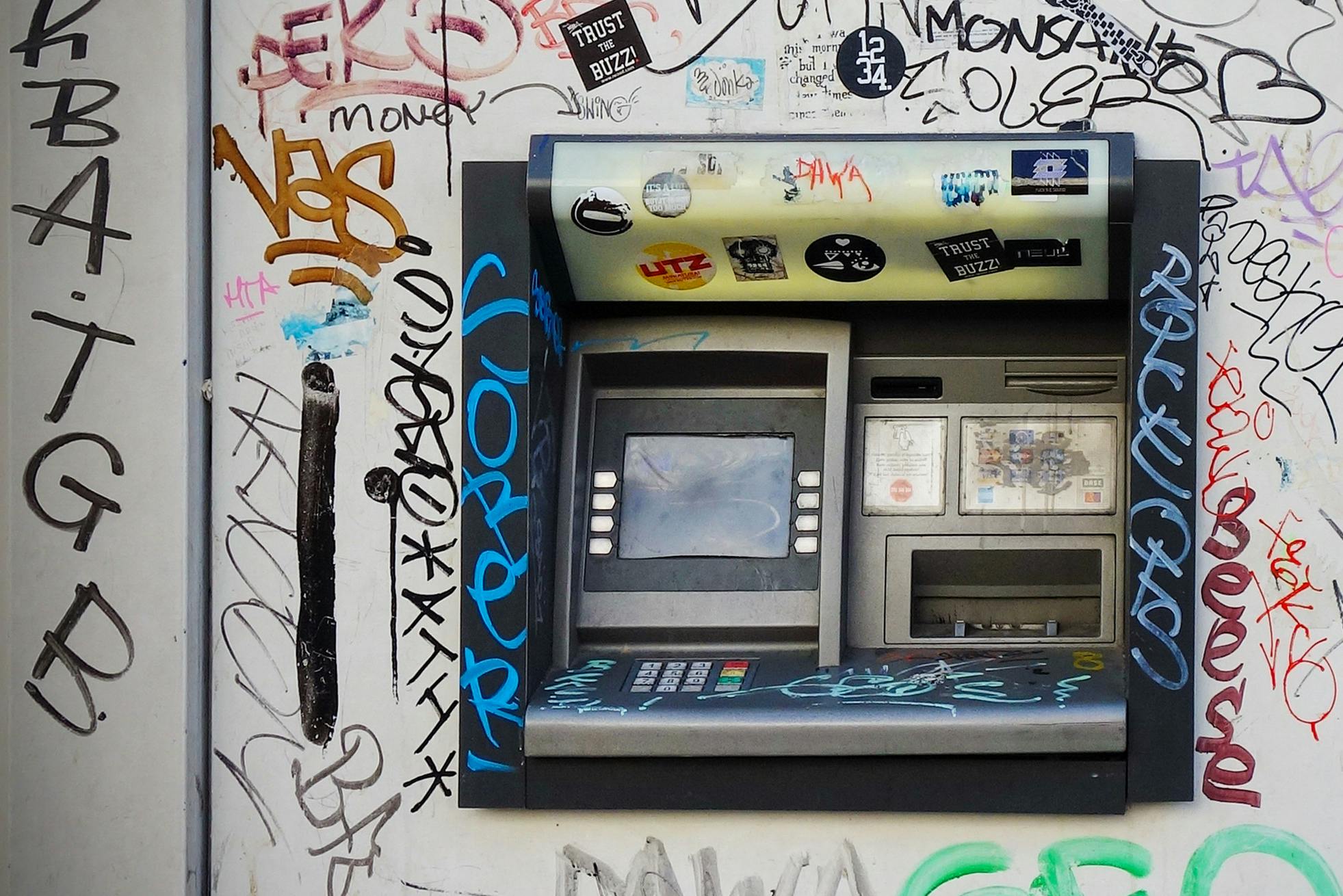 an old pay phone is covered with graffiti