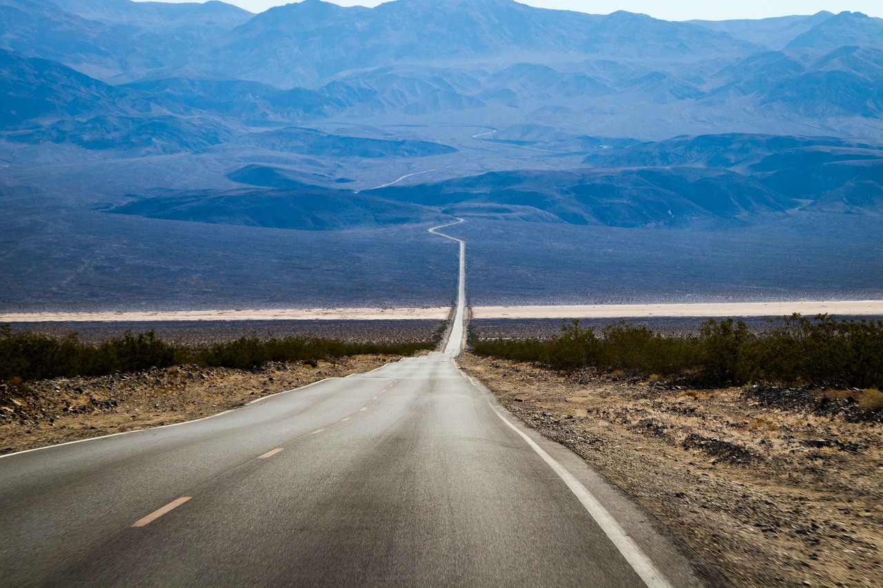 an empty road with mountains in the background, by Andrew Domachowski, shutterstock, death valley, background image, usa-sep 20, a road leading to the lighthouse