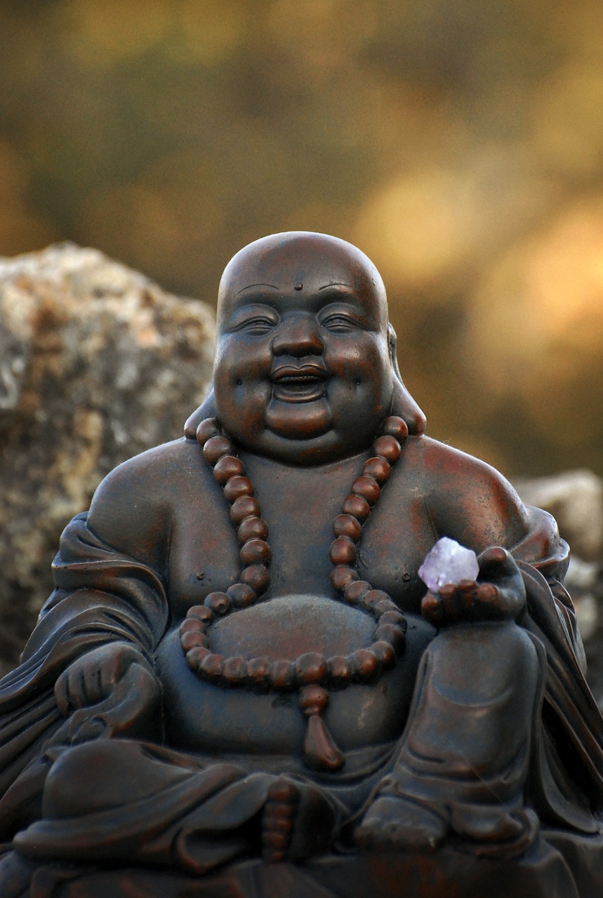 a statue of a laughing buddha sitting on a rock, a statue, inspired by Shūbun Tenshō, wallpaper”, small smile, 中 国 鬼 节, bubbles ”