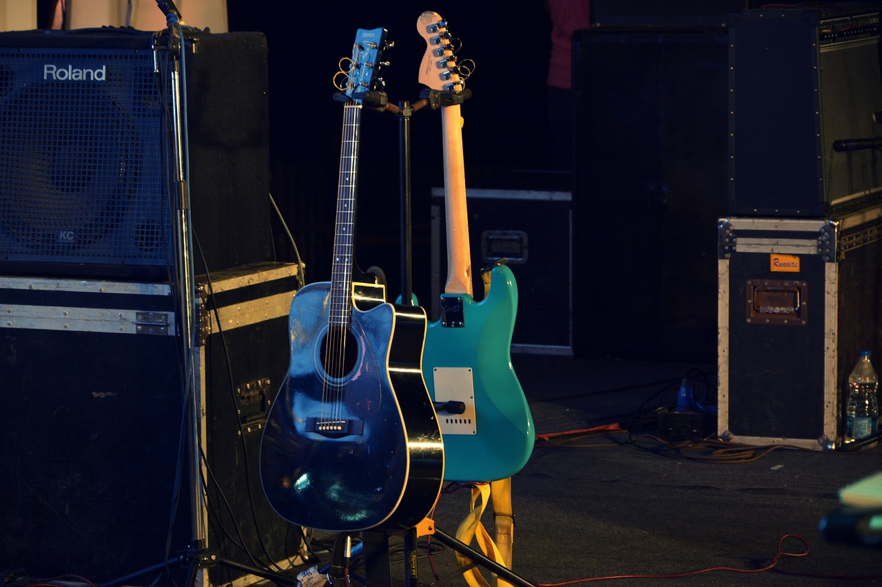 a group of guitars sitting on top of a stage, a picture, by Dicky Doyle, shutterstock, blue body, stock photo
