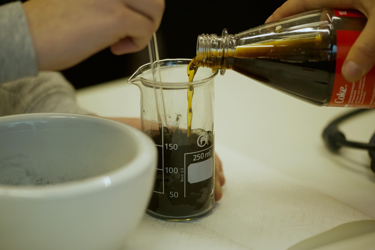 a person pouring a liquid into a beaker, process art, arabica style, closeup at the food, experiment in laboratory, japanese