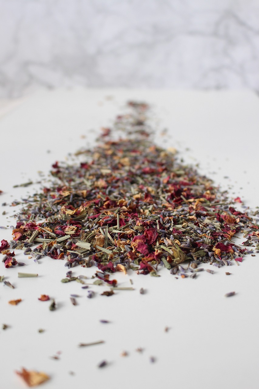 a pile of dried herbs sitting on top of a table, a picture, inspired by Annie Rose Laing, tumblr, close-up product photo, on a gray background, tea, red and purple palette