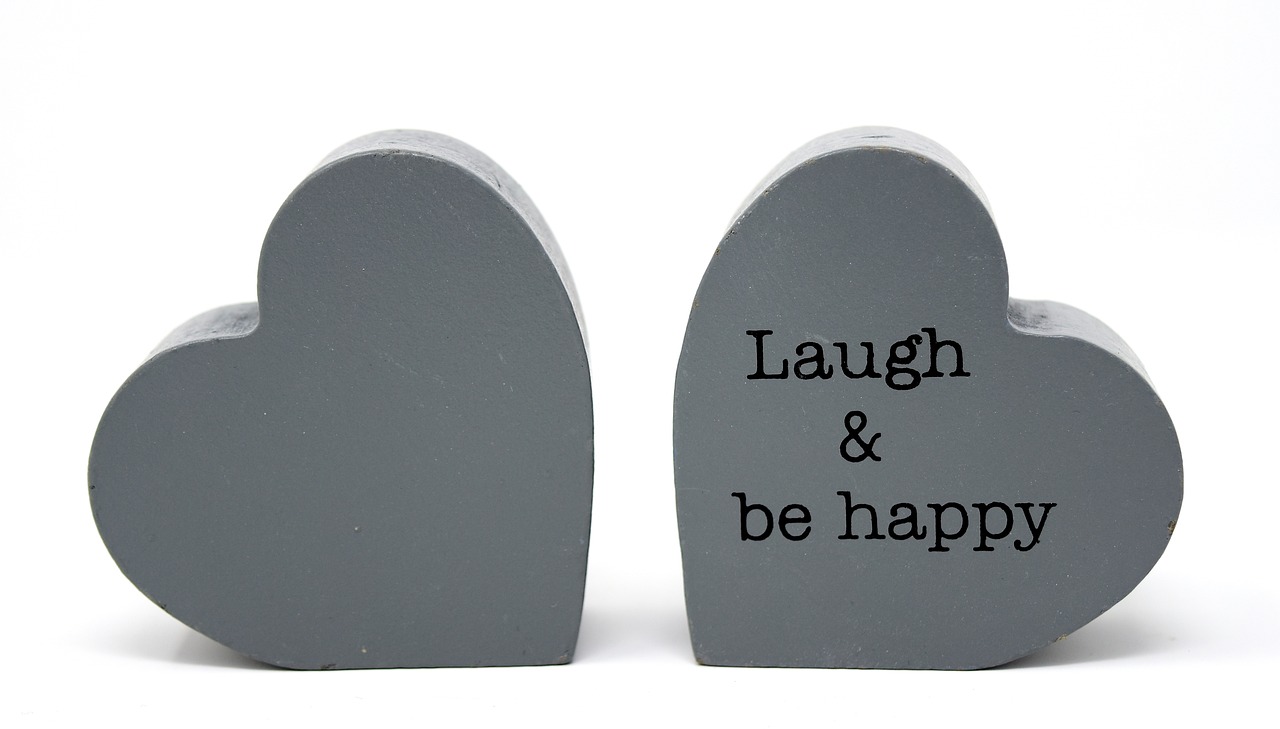 a pair of wooden hearts that say laugh and be happy, inspired by Hugh Hughes, slate, productphoto, figurines, tombstone