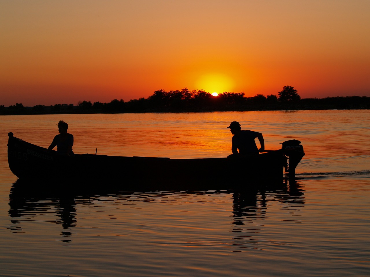 a couple of people that are in a boat, by Dietmar Damerau, flickr, hurufiyya, godrays at sunset, in an african river, joseph todorovitch ”, the photo shows a large