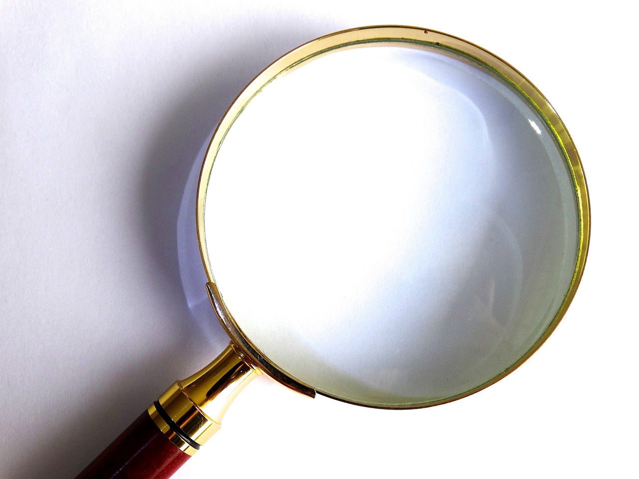 a close up of a magnifying glass on a table, by David Burton-Richardson, fix duplicate content!, perfect crisp light, golden, 'white background'!!!