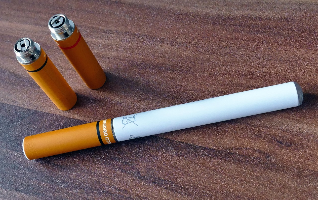 a couple of cigarettes sitting on top of a wooden table, a portrait, pixabay, happening, orange and white, syringe, high technology, highly detailed product photo