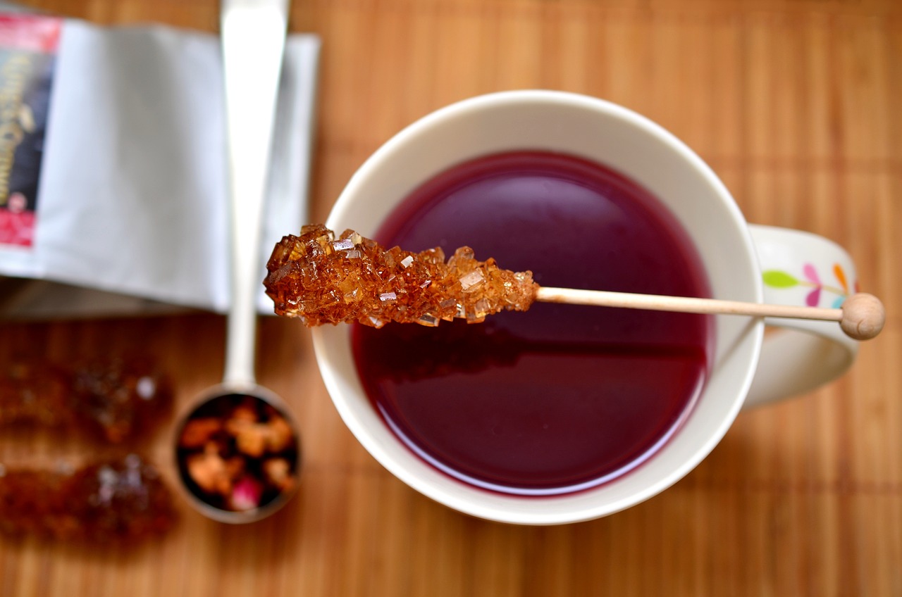 a cup of tea with a stick sticking out of it, inspired by Shūbun Tenshō, pexels, renaissance, jelly - like texture, natural point rose', grape, very crispy