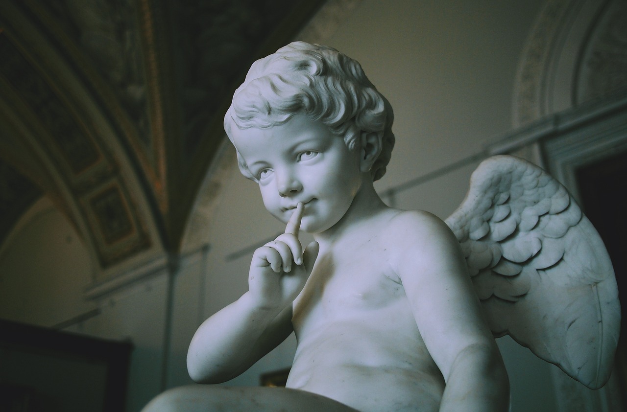 a close up of a statue of an angel, by Correggio, pexels, taking a smoke break, white marble interior photograph, cute boy, shot on nicon camera