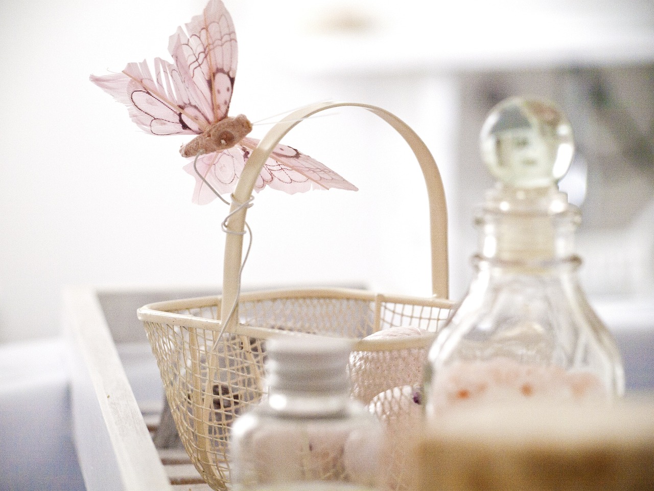 a close up of a basket with a flower in it, a picture, by Sylvia Wishart, pexels, white gossamer wings, cosmetics, bottle, furnished with fairy furniture