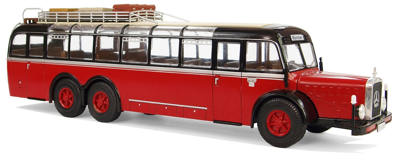 a red and black bus on a white surface, photo of a model, otto mueller, clear detailed view, with a roof rack