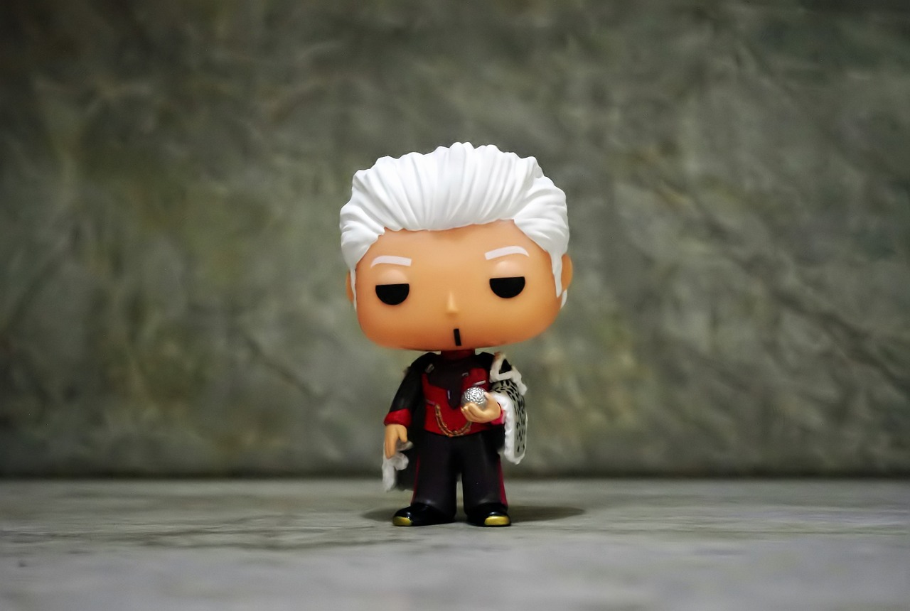 a close up of a toy on a table, a character portrait, inspired by Kanō Hōgai, unsplash, pop art, son of sparda, funko pop, old male archmage, royal elegant pose