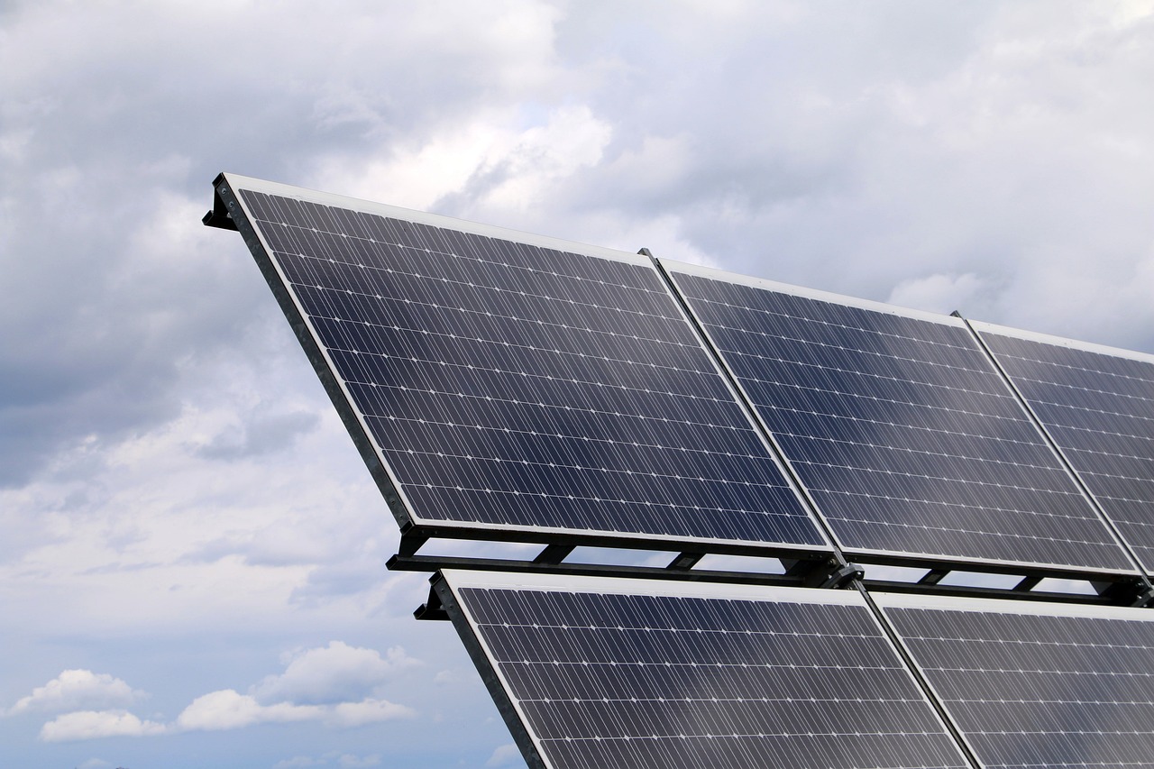 a row of solar panels against a cloudy sky, photostock, mid shot photo, no gradients, dezeen