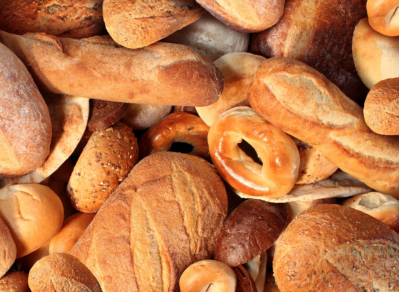 a pile of bread and pretzels sitting on top of each other, inspired by Normand Baker, pexels, hyperrealism, background image, birdseye view, hd —h 1024, mineral grains