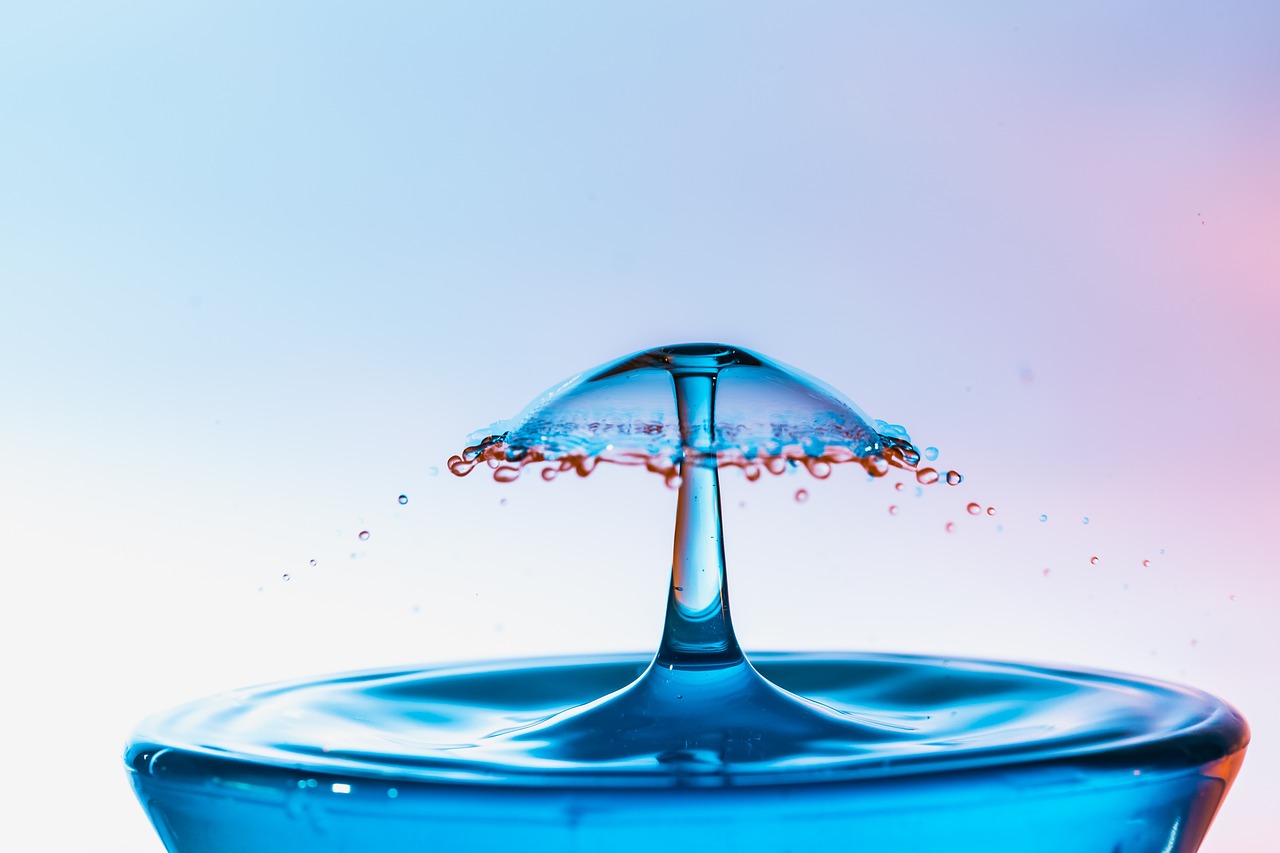 a water drop falls into a blue bowl, art photography, blue and pink colors, high detailed photo, detailed product photo, very sharp and detailed photo