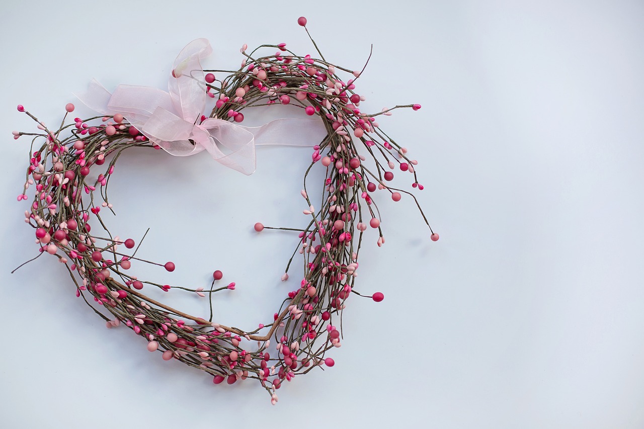 a heart shaped wreath with pink berries and a bow, romanticism, on a gray background, twigs, medium wide shot, view from the bottom