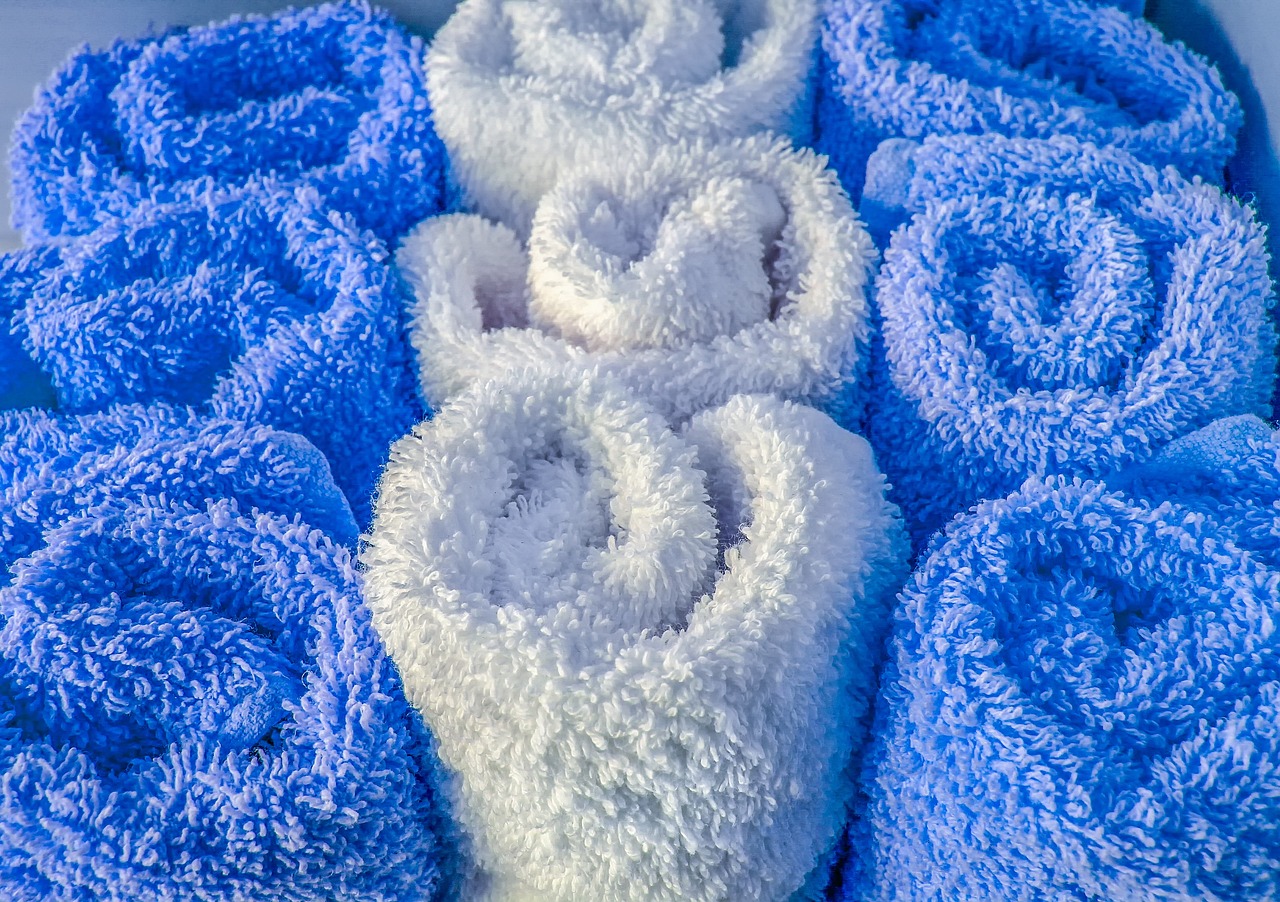 a bunch of blue towels stacked on top of each other, a macro photograph, by Arnie Swekel, process art, white spiral horns, hearts, detailed white, detailed zoom photo