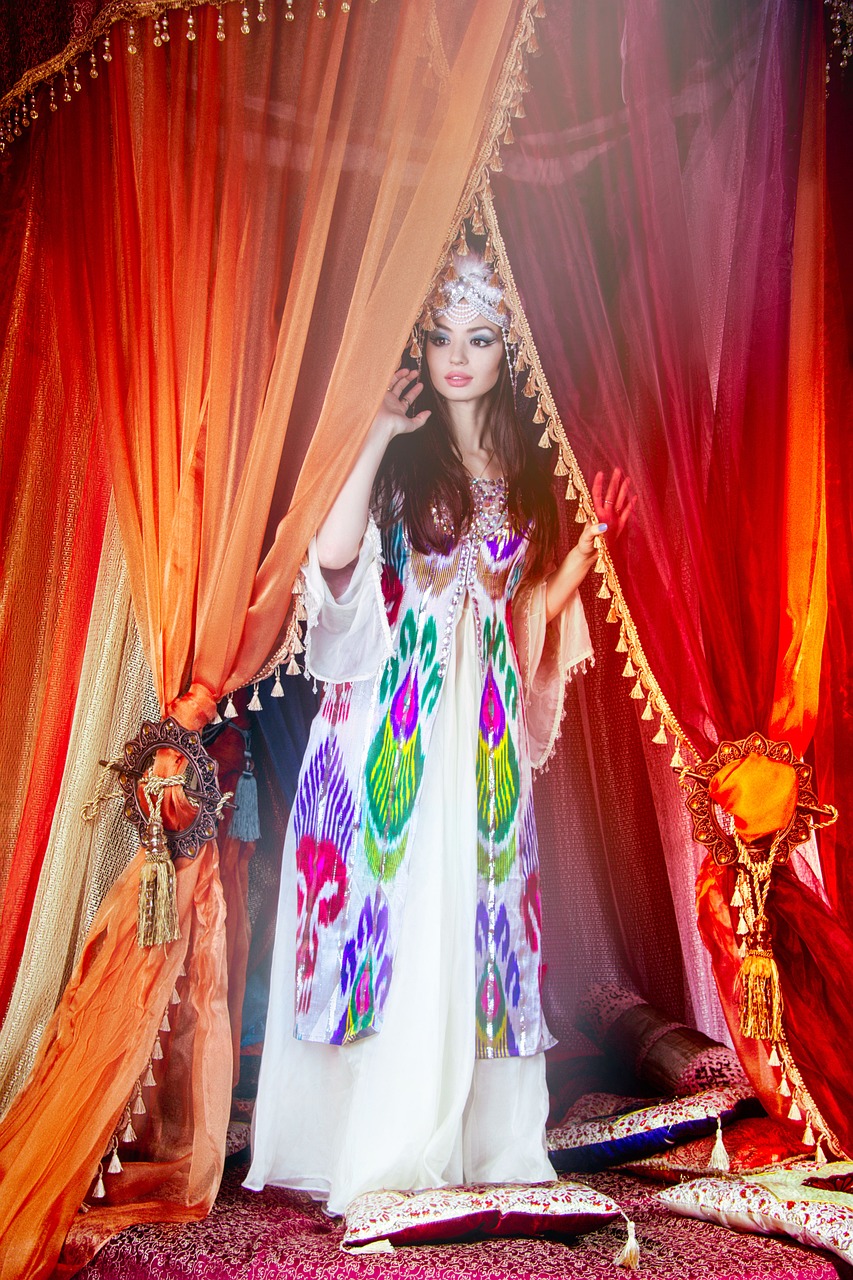 a woman in a colorful dress standing in front of a curtain, inspired by Cecil Beaton, baroque, arabian nights inspired, in a colorful tent, fashion magazine editorial, ancient asian dynasty princess