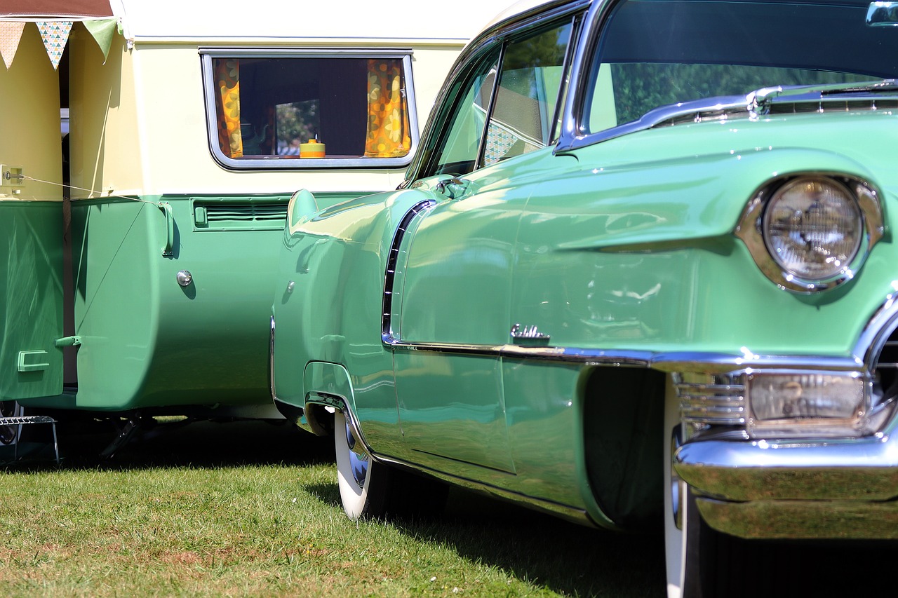 a couple of green cars parked next to each other, by Edward Corbett, pixabay, retrofuturism, camping, lowrider style, detail shots, trailer