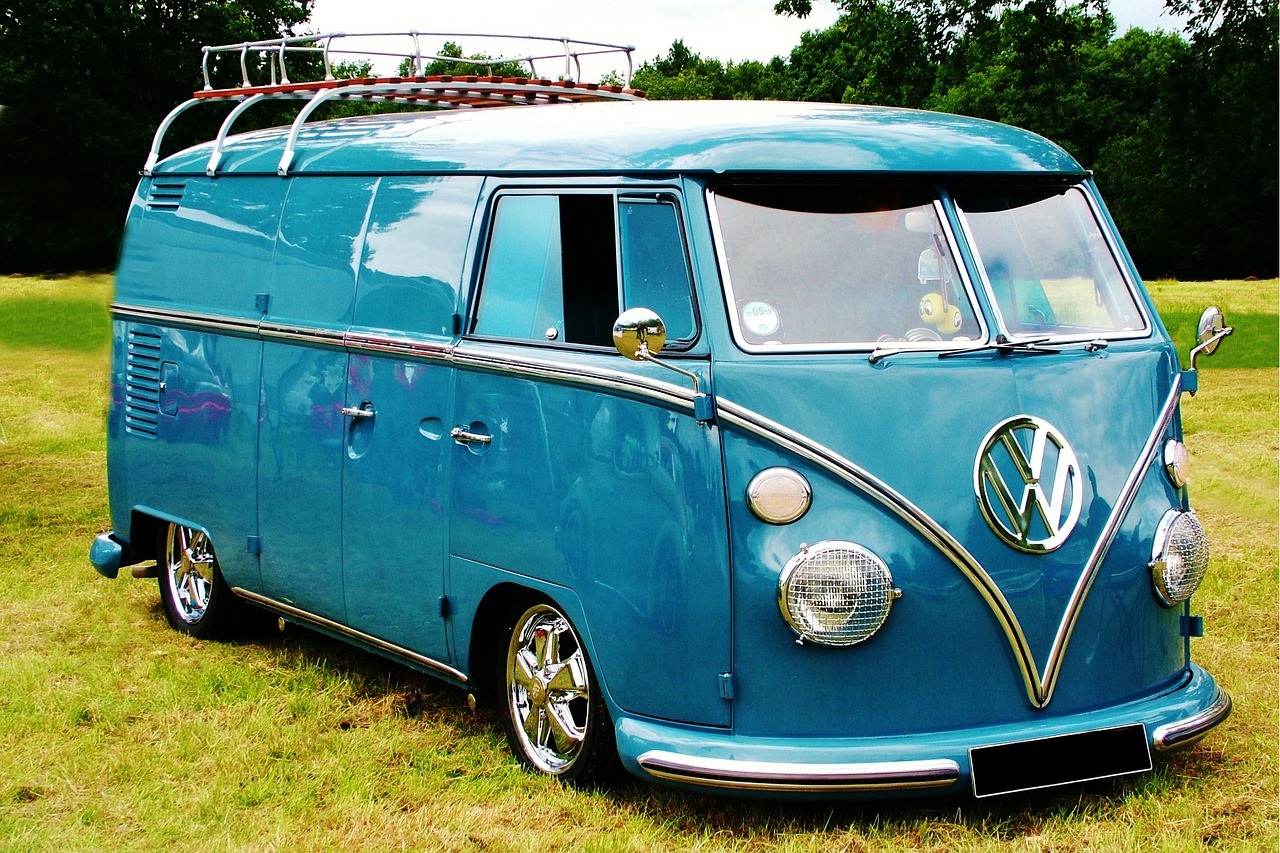 a blue vw bus parked on top of a grass covered field, flickr, retrofuturism, extremely polished, edited, classic cars, no duplicate image