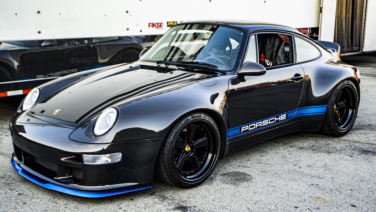 a black and blue porsche parked in a parking lot, by Jason Felix, wide body, pristine and clean, on a street race track, edd