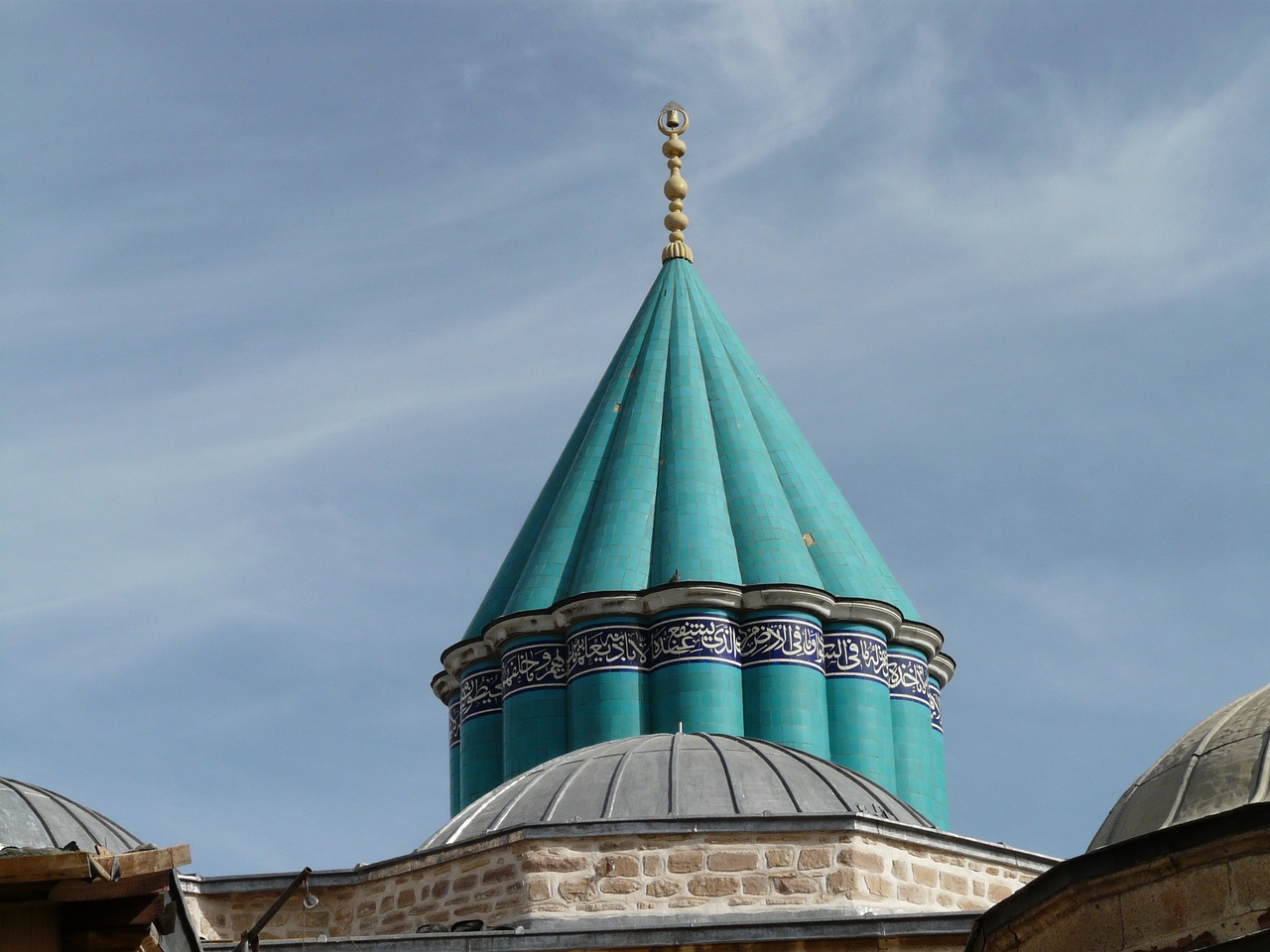 a clock that is on the side of a building, inspired by Osman Hamdi Bey, hurufiyya, pointy conical hat, turquoise color scheme, inside a dome, late 1 9 th century