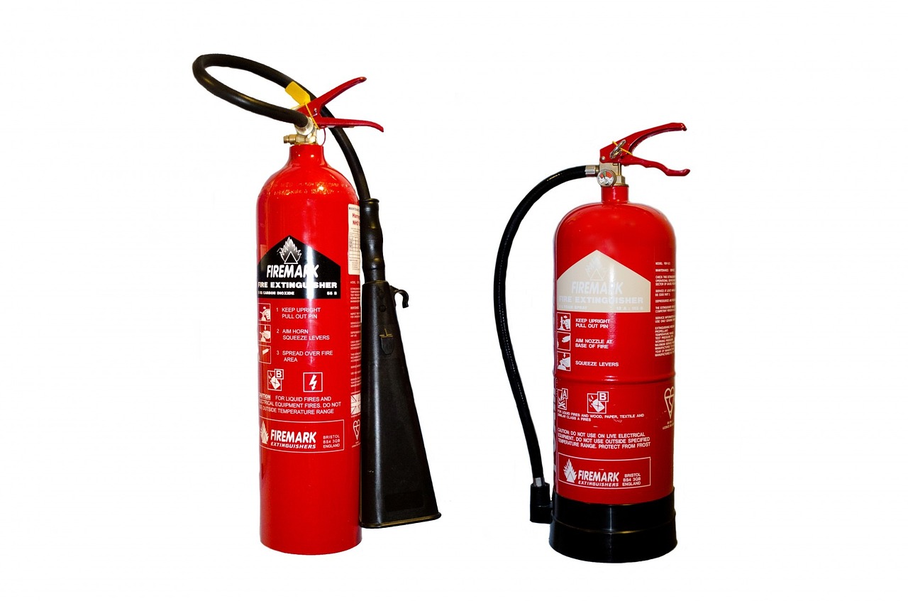 a red fire extinguisher next to a black fire extinguisher, a photo, by Alexander Fedosav, pixabay, art nouveau, i_5589.jpeg, фото девушка курит, tanks, jcb