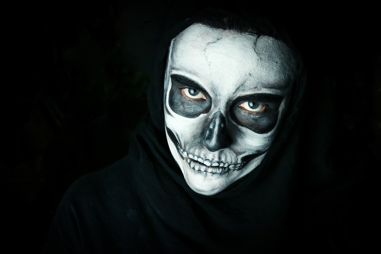 a close up of a person wearing a skeleton mask, a portrait, by Adam Szentpétery, pexels contest winner, face is wrapped in a black scarf, evil woman, white face paint, creepy hd 4k