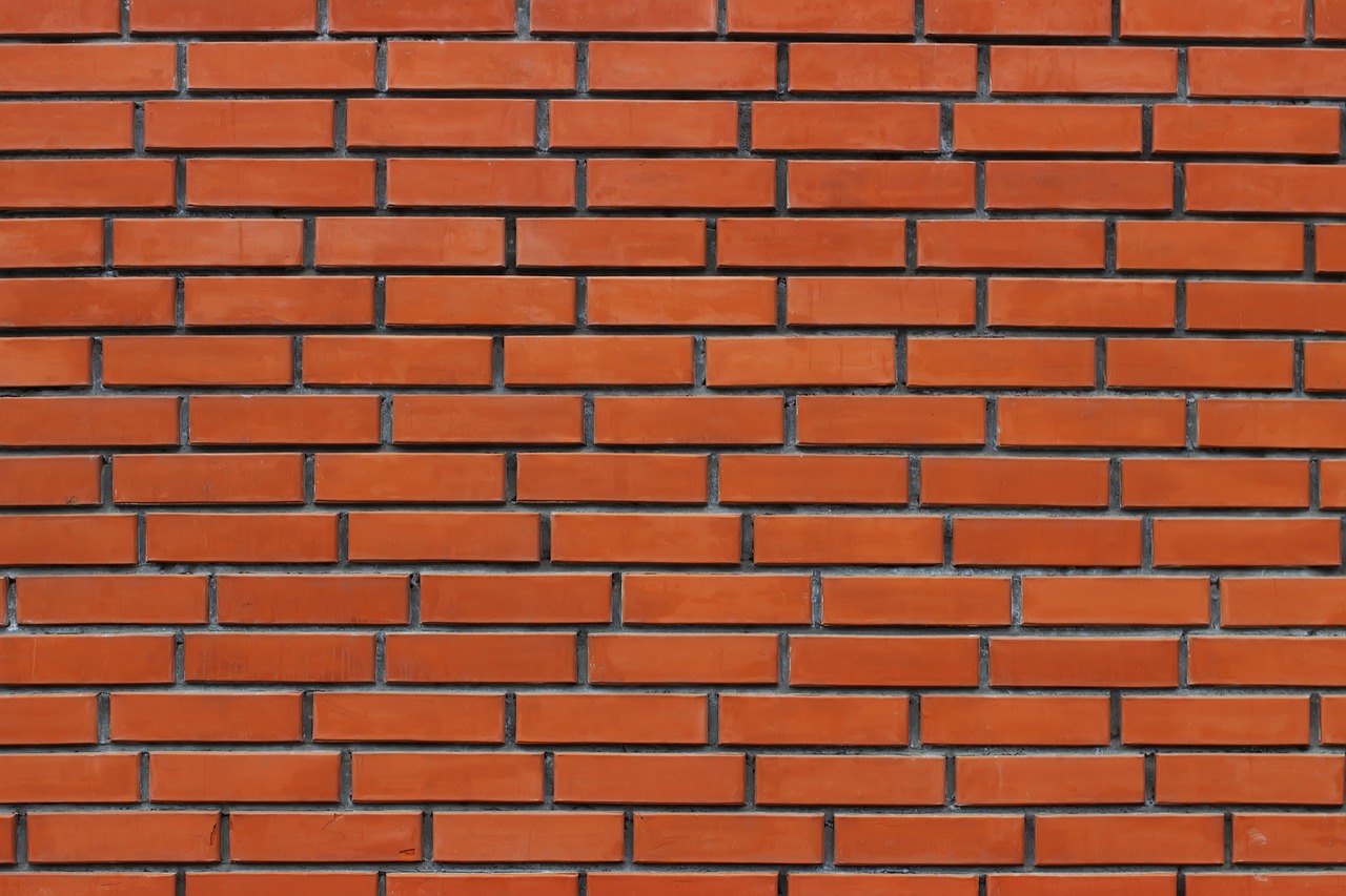 a fire hydrant in front of a brick wall, by Yi Jaegwan, minimalism, perfectly tileable, brick wall texture, face photo