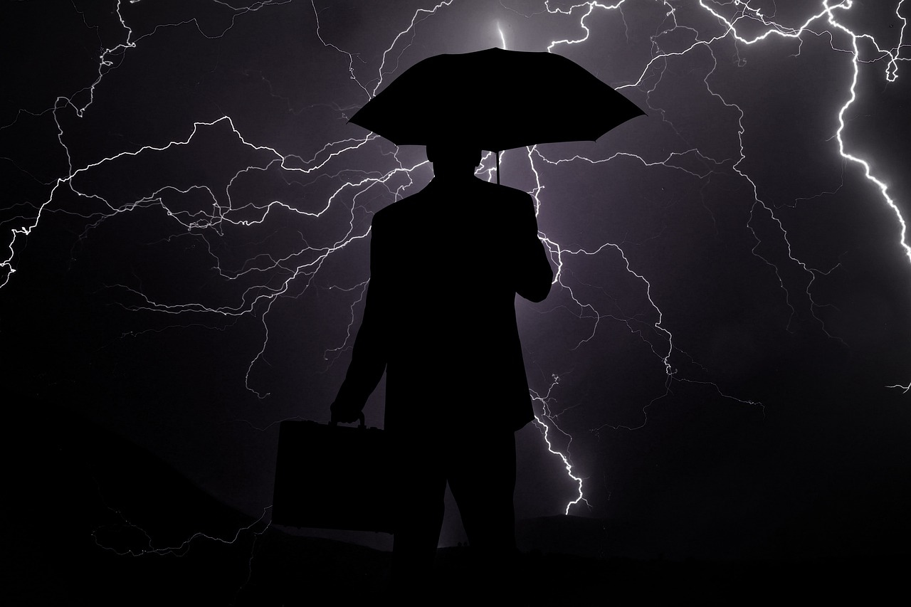 a silhouette of a person holding an umbrella, lightning helmet, serious business, istockphoto, thunders