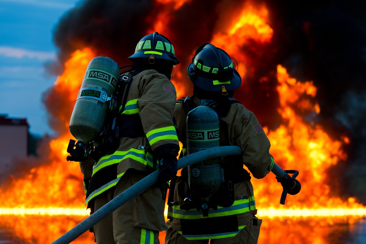 a group of firefighters standing next to each other in front of a fire, a picture, shutterstock, hd wallpaper, 360º, afp, edited