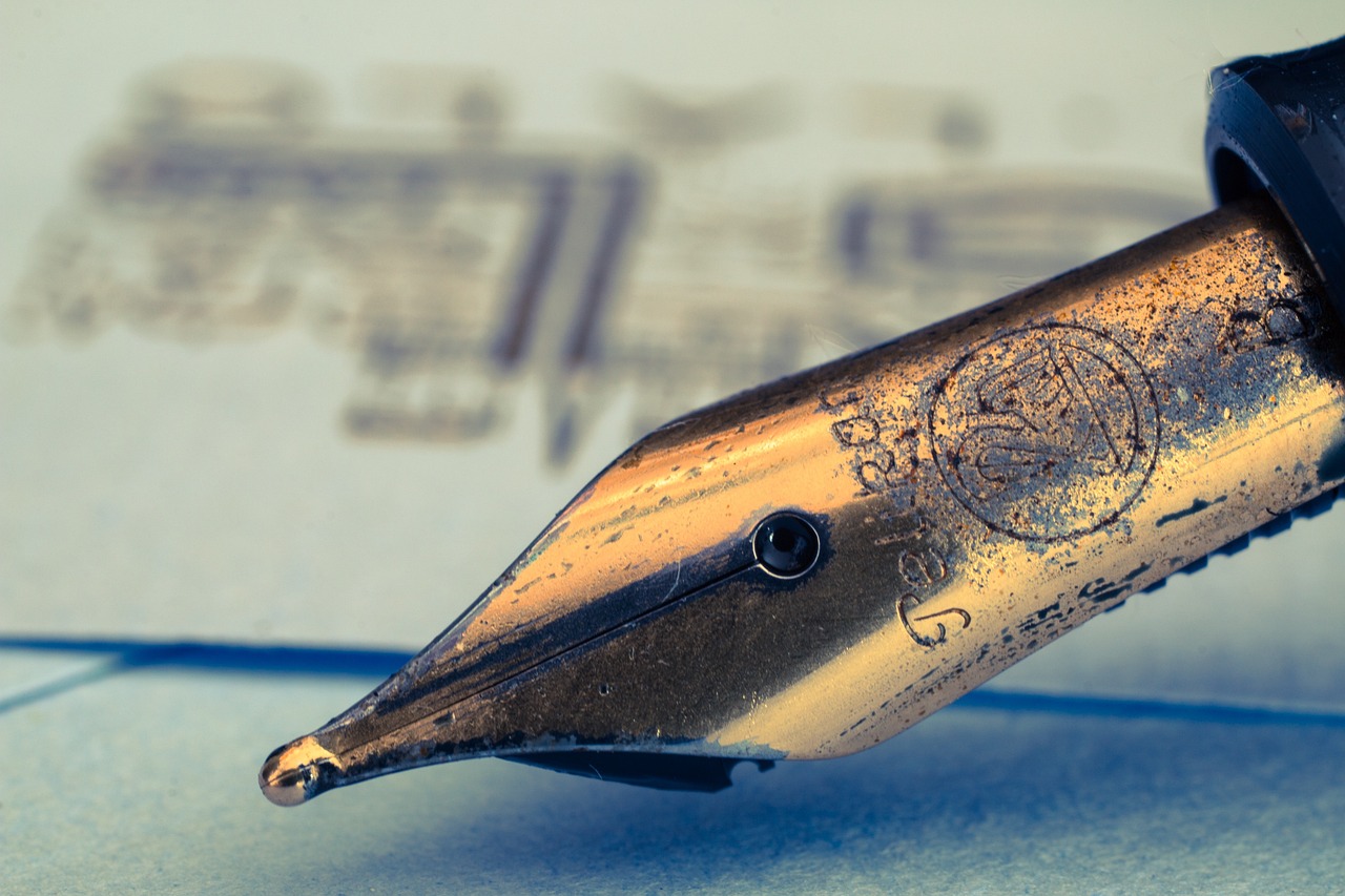 a fountain pen sitting on top of a piece of paper, a macro photograph, by Jesper Knudsen, intricate writing, closeup 4k, brass beak, rubber stamp