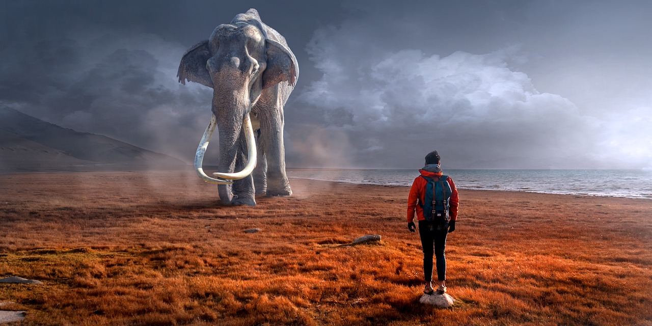a man standing in a field next to an elephant, digital art, pexels contest winner, surrealism, huge bull emerging from the sand, an elephant octopus chimera, distant thoughtful look, archeological discover