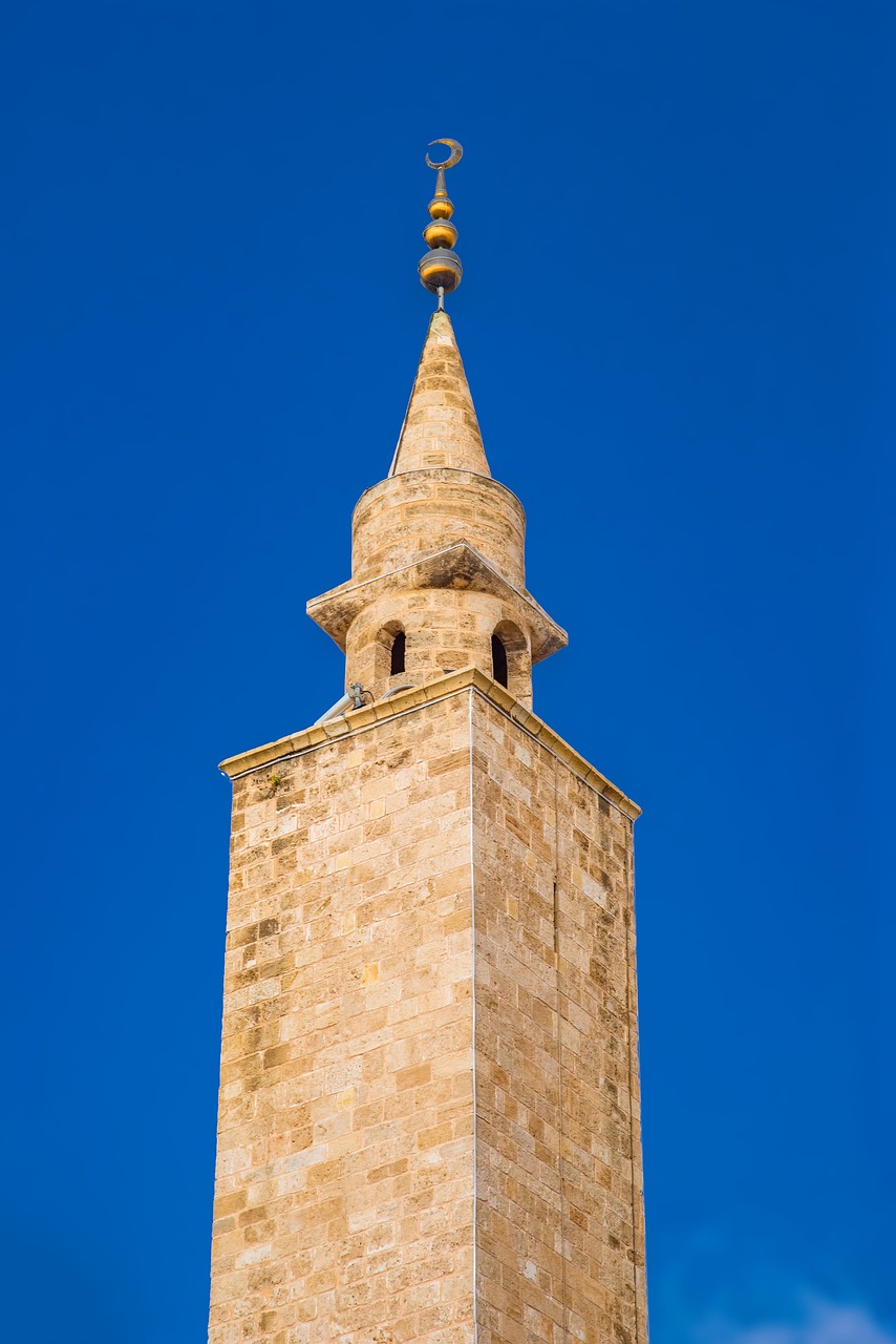 a tall tower with a clock on top of it, by Richard Carline, shutterstock, romanesque, old town mardin, high definition detail, stock photo, cone shaped