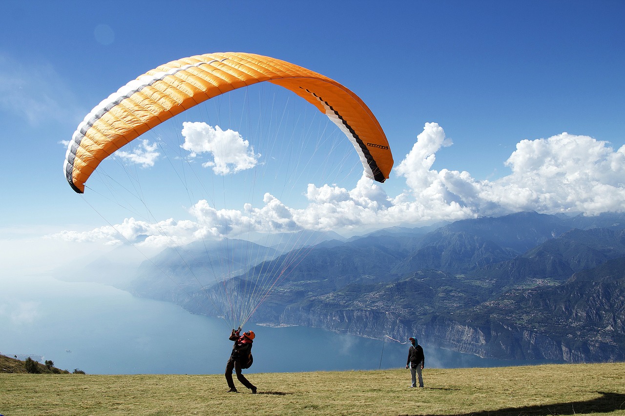 a couple of people that are flying a kite, a picture, by Shen Che-Tsai, shutterstock, breathtaking himalayan landscape, gondola, at takeoff, over the ocean