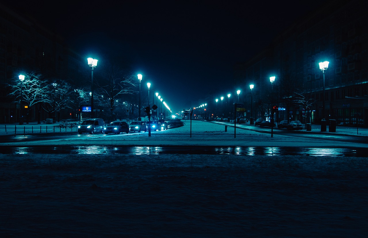 a street filled with lots of traffic at night, by Alexander Bogen, pexels contest winner, realism, cold blue colors, winter park background, in empty!!!! legnica, 4 k cinematic photo