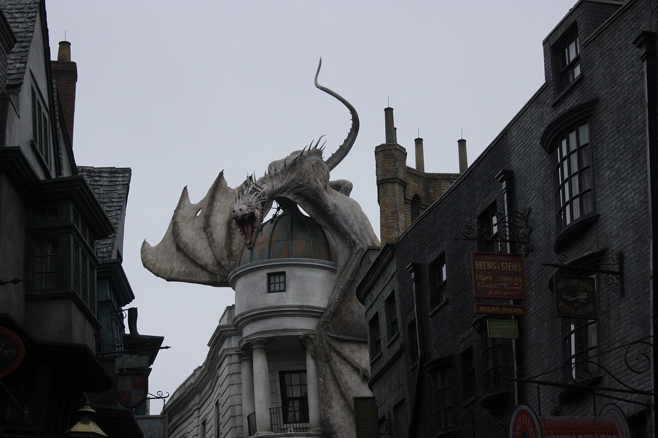 a statue of a dragon on top of a building, by Fuller Potter, flickr, harry potter!!, sandworm, shot from a distance, located in a wizard's shop