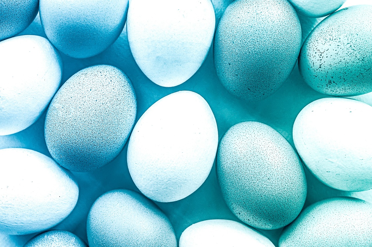 a bunch of blue and white eggs laying on top of each other, a stock photo, shutterstock, symbolism, gradient pastel green, glowing hue of teal, colourful close up shot, textured turquoise background