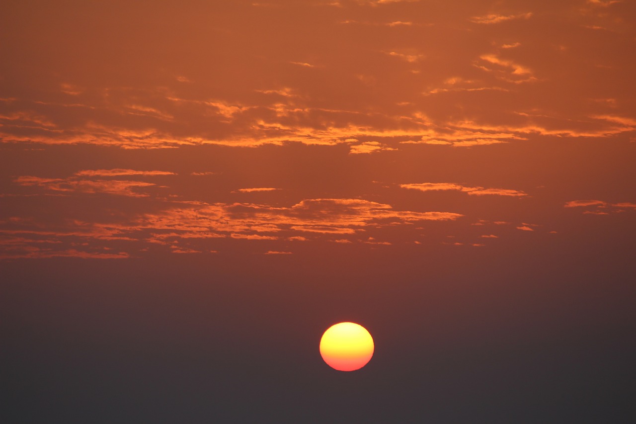 the sun is setting over a body of water, a picture, romanticism, orange sun set, the photo was taken from afar, very beautiful photo, visible sky and humid atmosphere