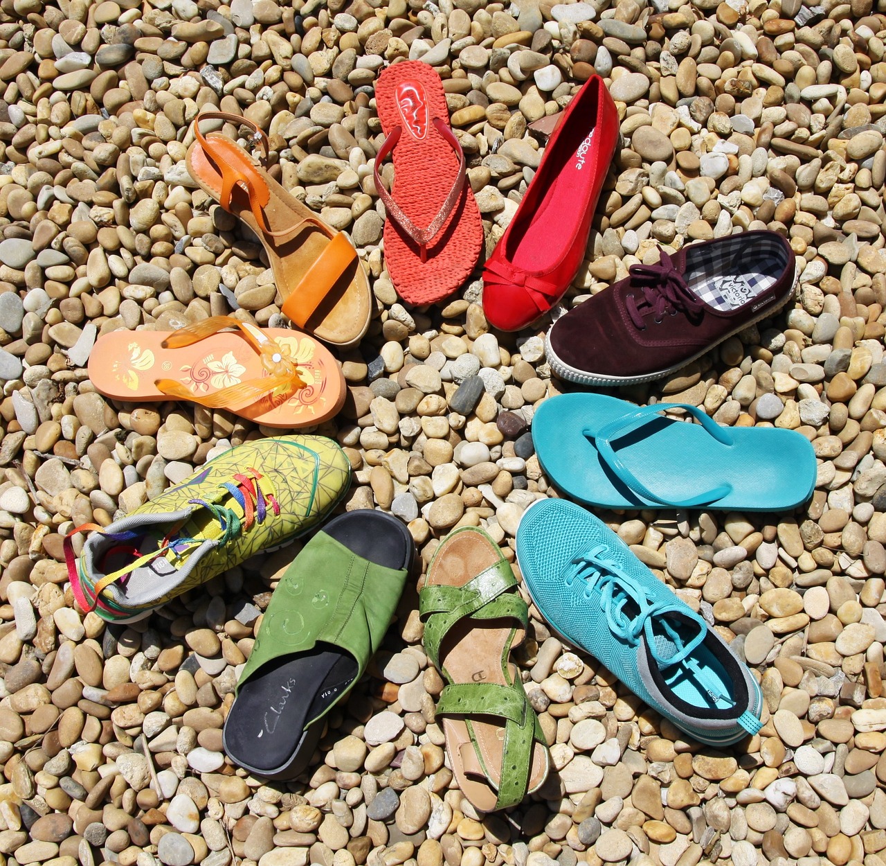 a group of colorful shoes sitting on top of a pile of rocks, by Robert Medley, overhead sun, various styles, ten flats, high res photo