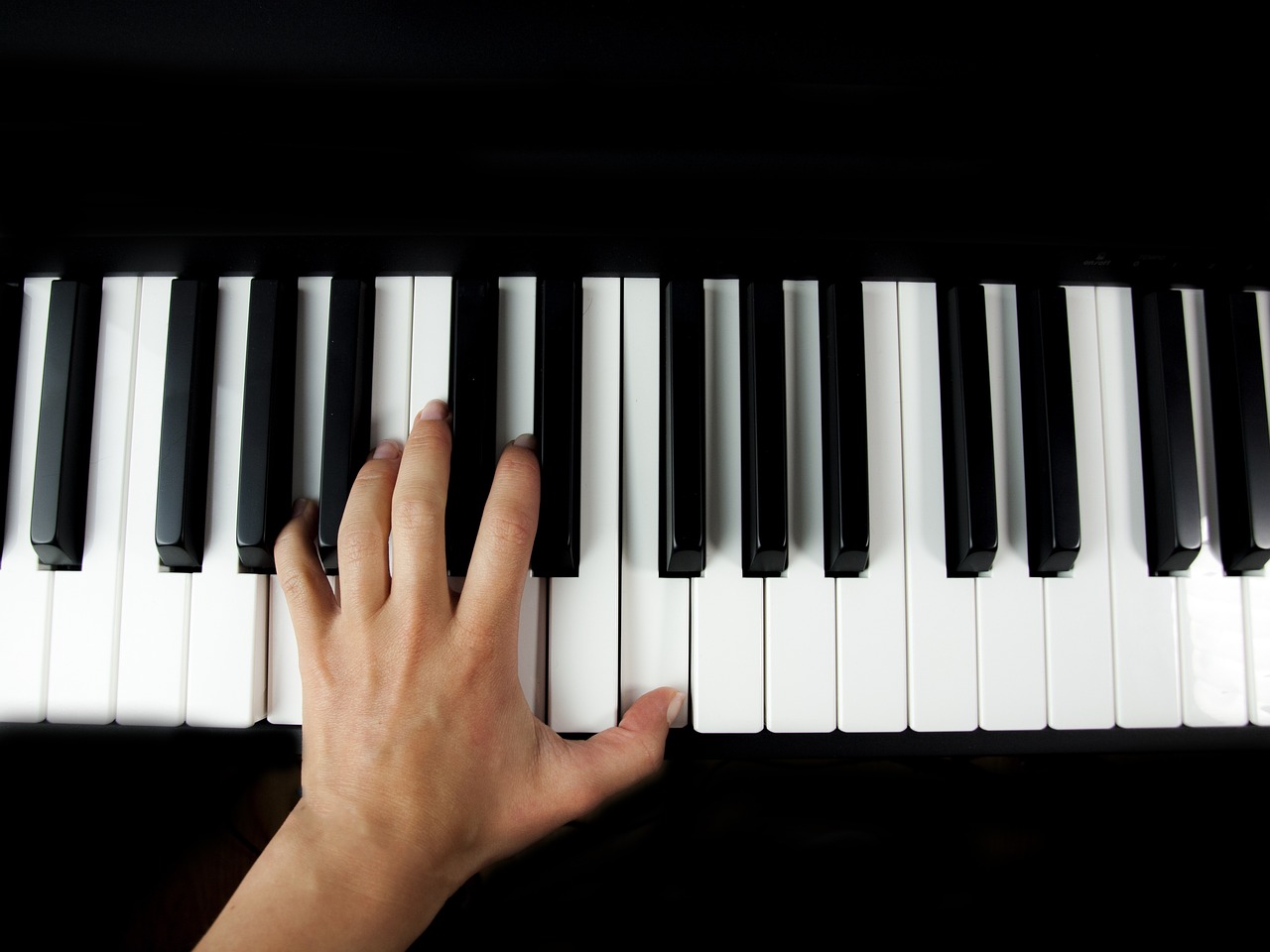 a close up of a person playing a piano, inspired by Kawai Gyokudō, shutterstock, synthetism, on black background, half - length photo, realistic fingers, seen from straight above