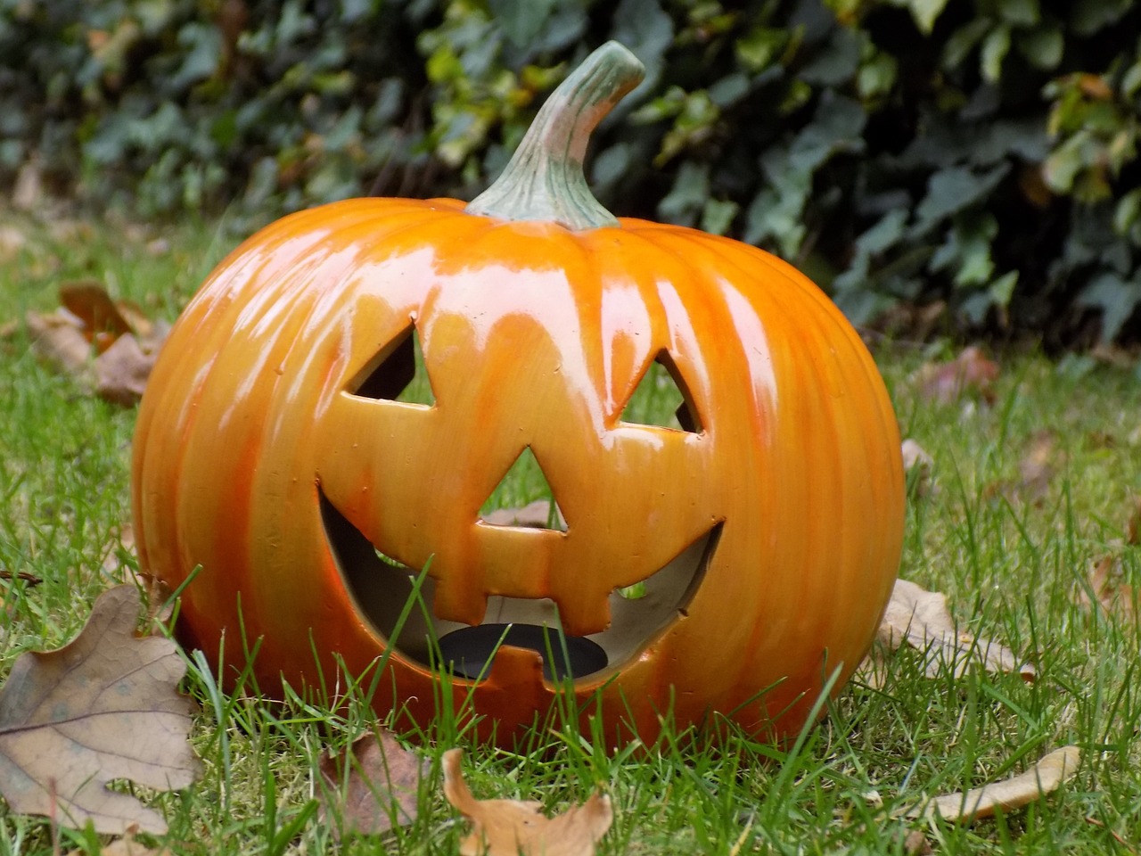 a pumpkin sitting on top of a lush green field, made of glowing wax and ceramic, shiny crisp finish, uploaded, english