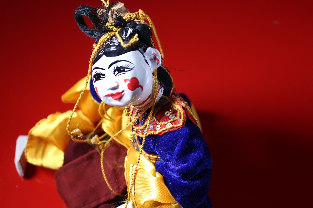 a close up of a figurine of a clown, inspired by Jin Nong, flickr, string puppet, wearing ancient chinese clothes, handsome girl, online