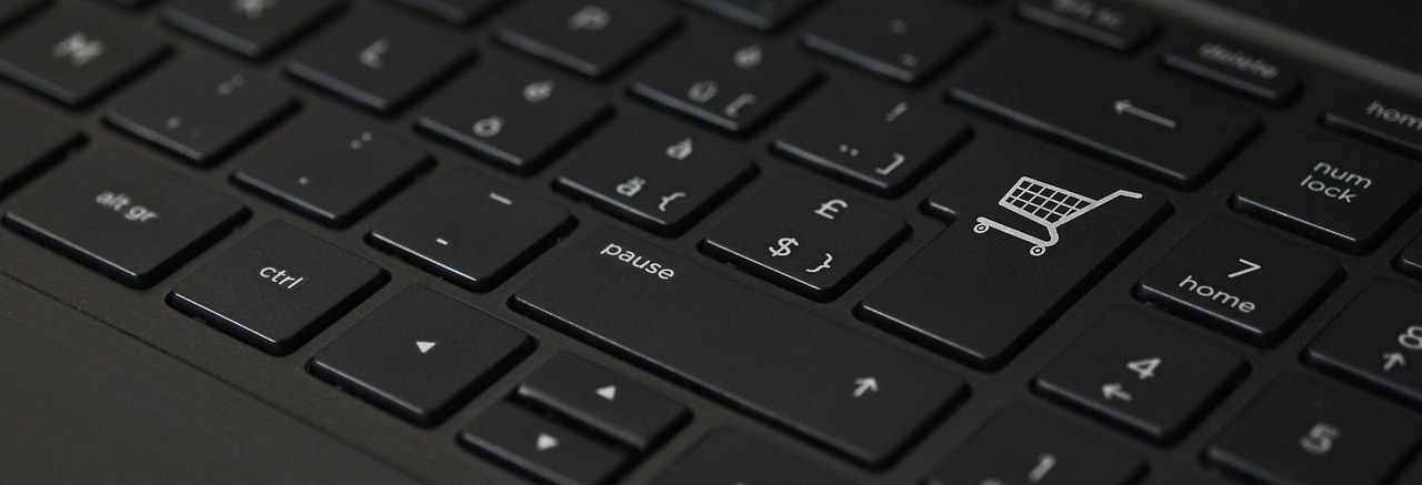 a close up of a keyboard with a shopping cart on it, pixabay, black lacquer, user interface, using a macbook, heavy gesture style closeup