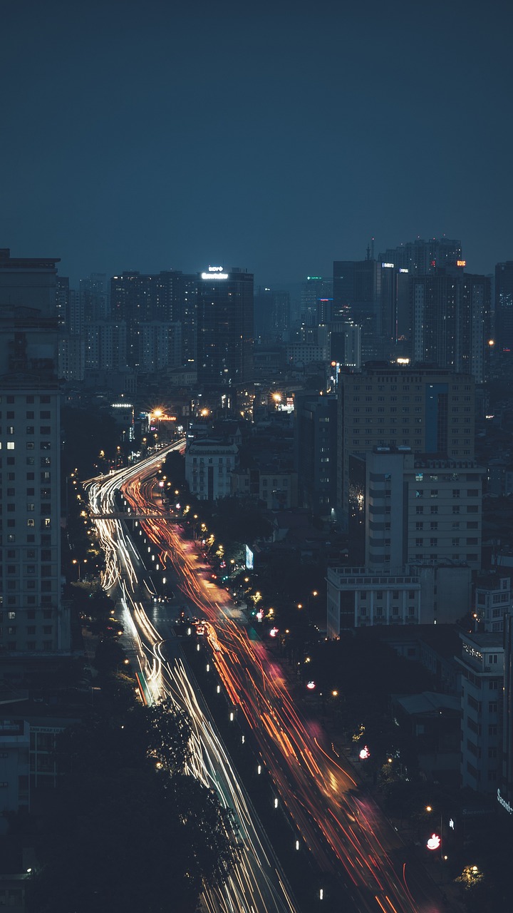 an aerial view of a city at night, by Sebastian Vrancx, unsplash contest winner, vietnam, hq 4k phone wallpaper, car traffic, gloomy