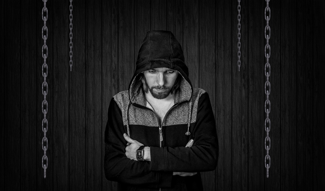 a black and white photo of a man in a hoodie, inspired by Adam Szentpétery, trending on pixabay, digital art, chains, a wooden, concerned expression, jesse pinkman