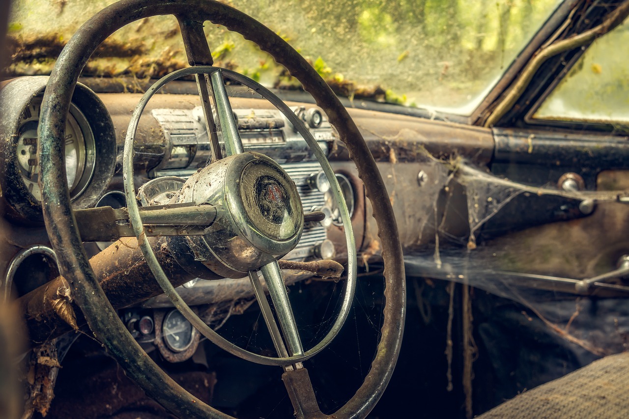 a steering wheel and dashboard of an old car, a portrait, by Thomas Häfner, pexels contest winner, auto-destructive art, stuck in mud, hyperdetailed!, wallpaper - 1 0 2 4, looking partly to the left