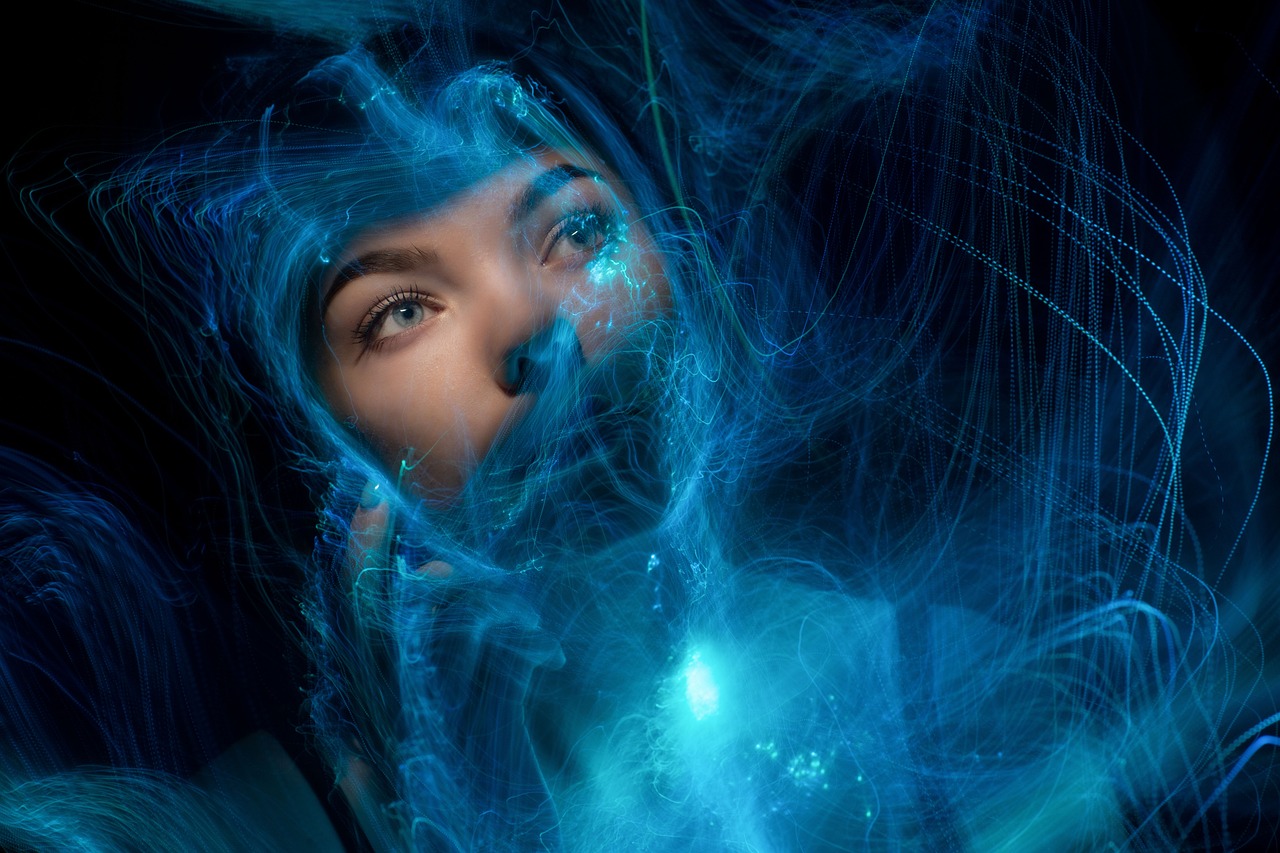 a close up of a person with blue hair, digital art, digital art, wisps of energy in the air, photo of young woman, morphosis, filled with bioluminescence