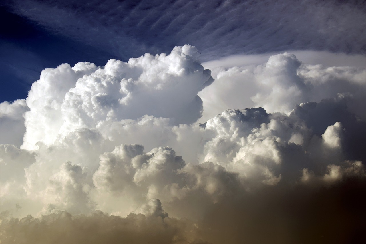 a plane flying through a cloud filled sky, a picture, by Hans Schwarz, cumulus clouds, extreme hight detail, evening storm, up-close