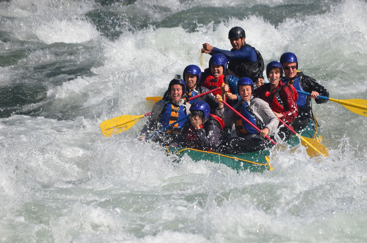 a group of people riding a raft on top of a river, a picture, flickr, hurufiyya, bearing a large mad grin, extreme panoramic, closeup photo, iwakura