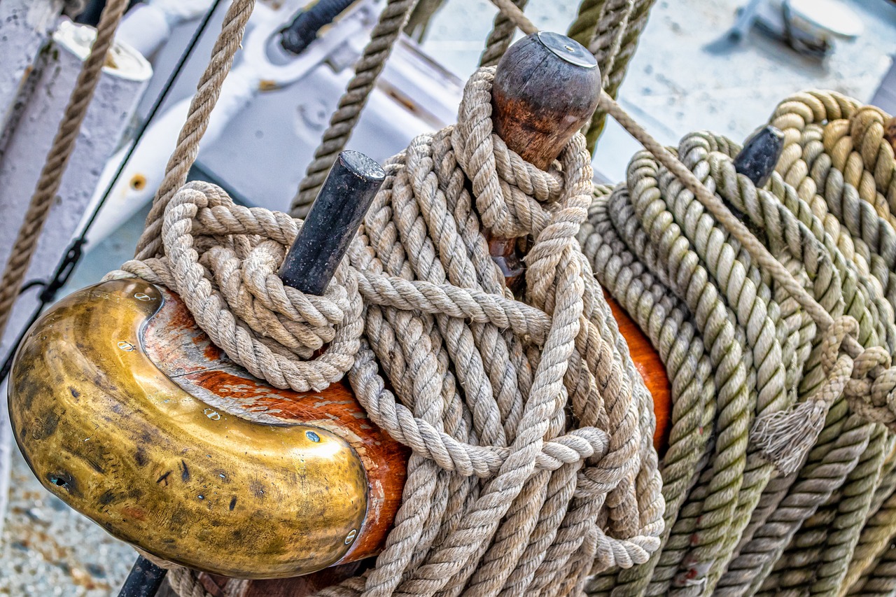 a close up of a rope on a boat, a portrait, by Raymond Normand, shutterstock, wooden sailboats, hdr detail, photograph taken in 2 0 2 0, very very well detailed image